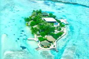 an island with a resort in the water at EDEN Private Island TAHAA in Patio