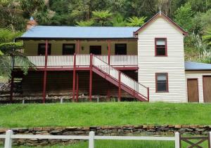 a house with a large deck on the side of it at Whitlow Manor 3BR and optional 1BR studio in Walhalla