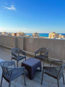 a group of chairs and a table on a roof at Almanara Hotel Marsa Matrouh in Marsa Matruh