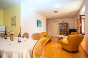 a living room with a table and chairs and a couch at House La Casa Simone in Jesenice