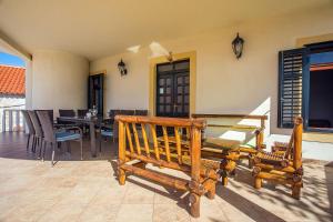 a patio with two wooden chairs and a table at House La Casa Simone in Jesenice
