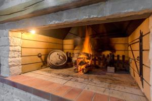 a large brick fireplace with a fire in it at Villa Lux in Vinišće