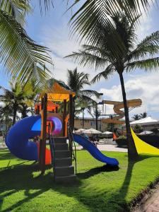a playground in a park with a slide at Porto Carleto Temporadas - Quarto no Portobello Park Hotel in Porto Seguro