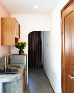 a kitchen with a sink and a counter top at Laholm Hotel - Apartment in Nha Trang