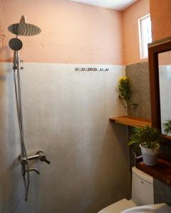 a bathroom with a toilet and a sink at Laholm Hotel - Apartment in Nha Trang