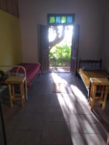 a room with two beds and a window and a door at Casa alma verde alegría y paz in Luyaba +20 photos