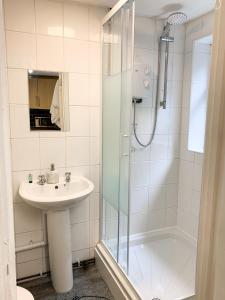 a bathroom with a sink and a shower at Free Parking Contractors Leisure National Park in Llwyn-y-pia