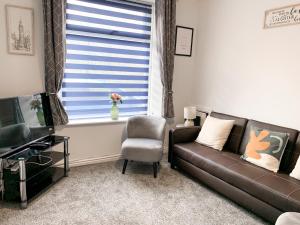 a living room with a couch and a chair and a window at Free Parking Contractors Leisure National Park in Llwyn-y-pia