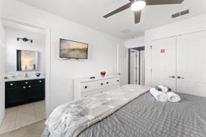a white bedroom with a large bed and a sink at *PRIVATE POOL* Disney10min - Magical Mickey themed home in Kissimmee +36 photos