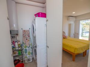 a kitchen with a refrigerator and a table in it at Magnifique 3P climatisé en dernier étage avec terrasse face mer, proche centre Menton - FR-1-196-326 in Menton +7 photos