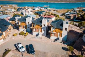 an aerial view of a house with a car parked in front at Cabañas Las Nubes in Puerto Deseado