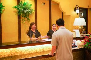 a group of people standing at a reception desk at The Pepperland Hotel in Legazpi