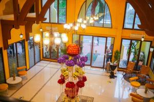 a lobby with a large vase filled with flowers at The Pepperland Hotel in Legazpi