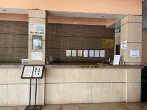 a ticket counter in a building with a phone at KUHARA COURT APARTMENT SUITE in Tawau