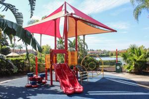 een speeltuin met een glijbaan in een park bij *PRIVATE POOL* Disney10min - Magical Mickey themed home in Kissimmee