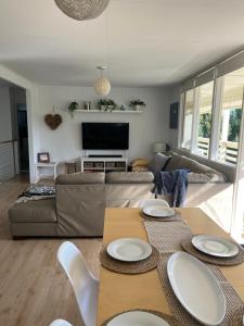 a living room with a couch and a table at Aldinga Beach Break - C21 SouthCoast Holidays in Aldinga Beach