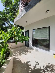 a house with a large window on the side of it at Green Peace Village in Da Nang