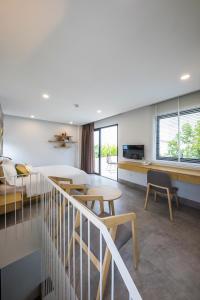 a hotel room with a bed and tables and chairs at Green Peace Village in Da Nang