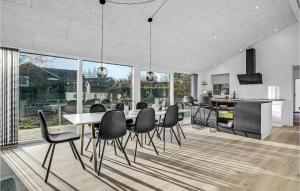 a dining room with a table and chairs at 4 Bedroom Nice Home In Glesborg in Glesborg