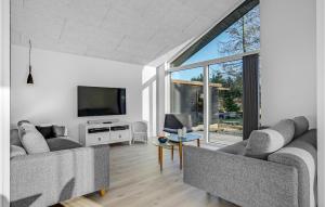 a living room with two couches and a television at 4 Bedroom Nice Home In Glesborg in Glesborg