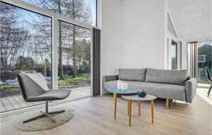 a living room with a couch and a table at 4 Bedroom Nice Home In Glesborg in Glesborg +17 photos