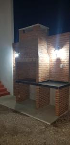 a brick fireplace with a table in front of it at Dpto Falucho in San Luis