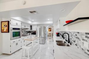 a kitchen with white cabinets and a fireplace at Ranch style villa with pool and spa in Las Vegas