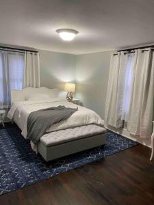 a bedroom with a bed with a blue rug at River House in South Williamsport