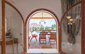 an arched doorway into a dining room with a table and chairs at 3 Bedroom Stunning Home In Vabriga in Vabriga