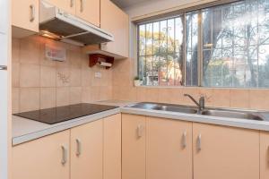 a kitchen with a sink and a window at 1 Private Double Room in Berala near Station close to Olympic Park in Regents Park
