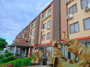 a statue of elephants in front of a building at Pruksa Siri View in Sara Buri