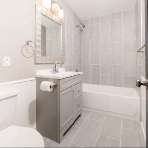a bathroom with a sink and a toilet and a tub at Spacious 3 BD Close To Everything! You’ll Love It! in Anchorage