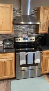 a kitchen with a stove top oven in a kitchen at Spacious 3 BD Close To Everything! You’ll Love It! in Anchorage