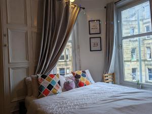 a bedroom with a bed and a large window at Huge room in the city in Edinburgh