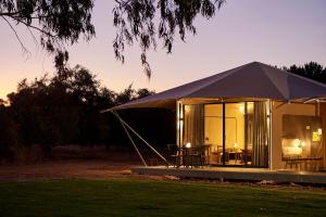 Tienda con mesa y sillas en un campo en Olio Bello Lakeside Glamping, en Cowaramup