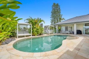 a swimming pool in the backyard of a house at SEACLUSION 5 bed waterfront, sleeps 12 in Gold Coast