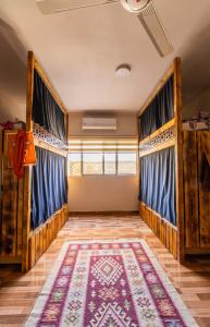 a room with blue curtains and a rug at Hakaia Community in Aqaba