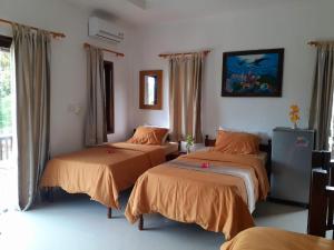 a room with two beds and a painting on the wall at Villa casamarbella in Karangasem +41 photos