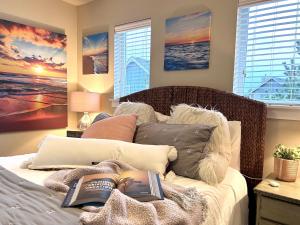 a bedroom with a bed with two books on it at Sip Sea Beach Cottage in Ocean Shores