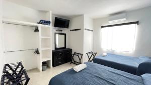 a bedroom with two beds and a tv and a mirror at Habitacion Privada Ejecutiva Minisplit Amenidades 2 in Castillo Teresa