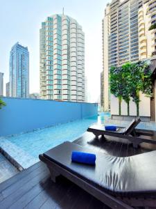 uma varanda com uma piscina e uma mesa e alguns edifícios em Citrus Sukhumvit 13 Nana Bangkok by Compass Hospitality em Banguecoque