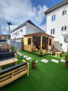 a backyard with green grass and a building at Palazzo Apartments in Ikeja