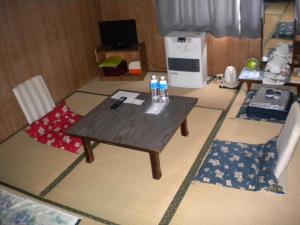 a table with two bottles of water on top of a room at Mimatsuso Ryokan in Asahikawa