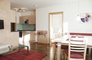 a kitchen and dining room with a table and chairs at Haus Sonneneck - ski in & out in Sankt Anton am Arlberg