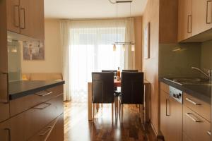a kitchen with a table and chairs in a room at Haus Sonneneck - ski in & out in Sankt Anton am Arlberg