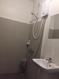 a bathroom with a shower and a sink at Mactan Airport Guesthouse in Cogon