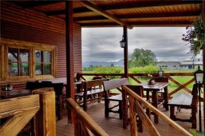 a patio with tables and chairs on a wooden deck at Penzion San Martin in Martin