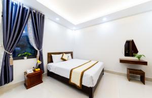 1 dormitorio con 1 cama y TV. en Đà Lạt Cao Nguyên Hotel en Dalat