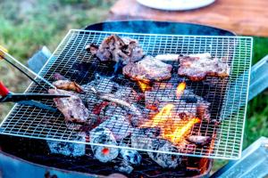 a grill with a bunch of meat on it at Sea and Wave in Seogwipo