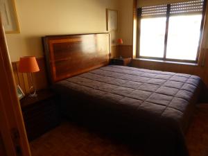 A bed or beds in a room at Apartment by the beach